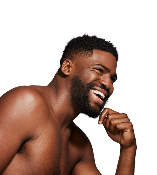 man laughing with hand on chin